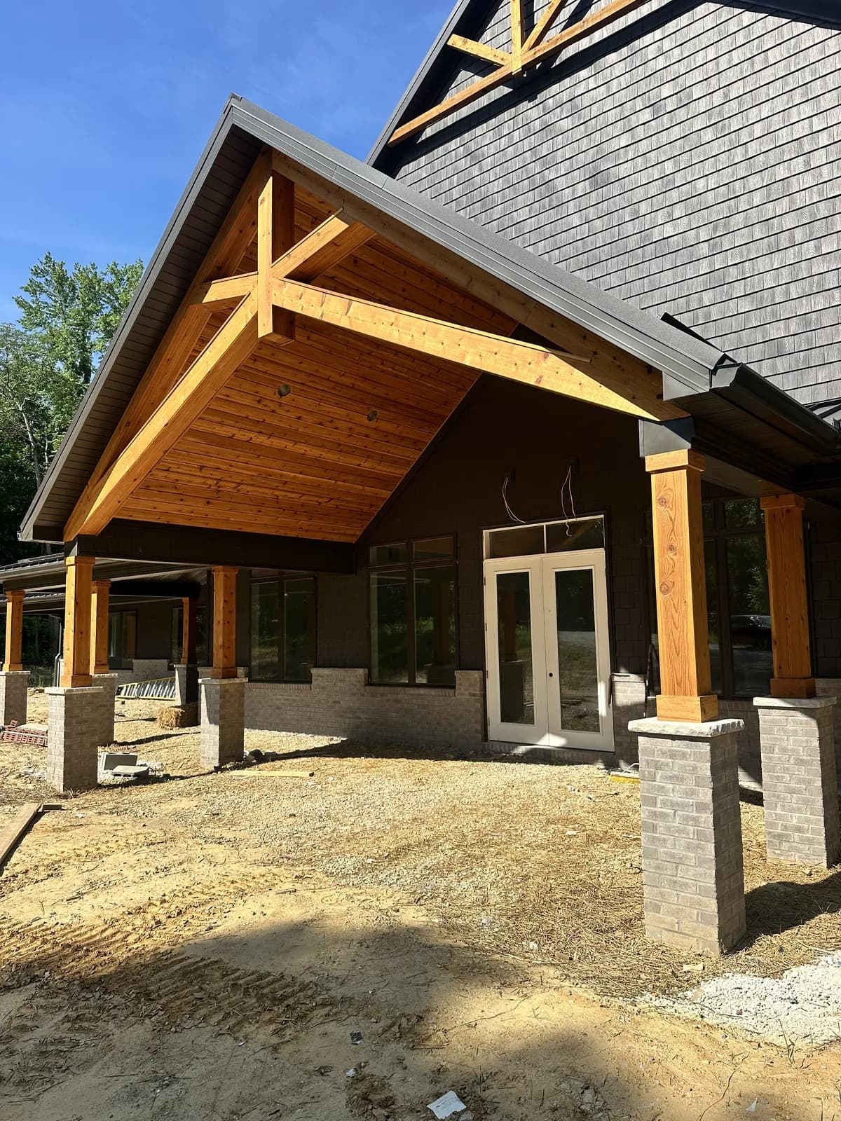 The lodge's timber-truss porch and stone columns