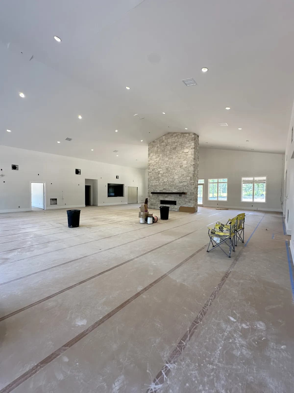 Inside the lodge great room, stone fireplace and vaulted ceiling