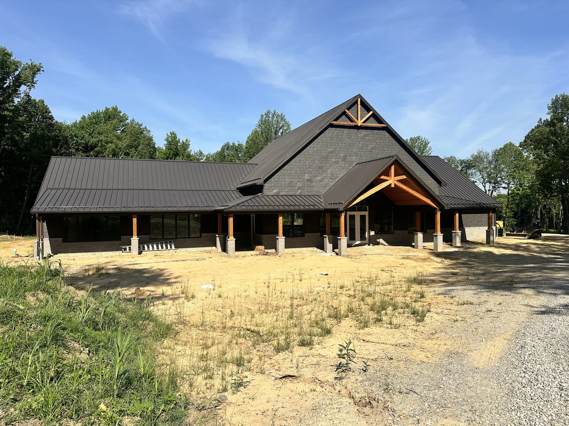 The lodge exterior, timber-frame gable and metal roof